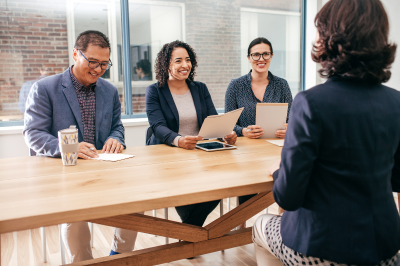 People from different backgrounds sit together at a table